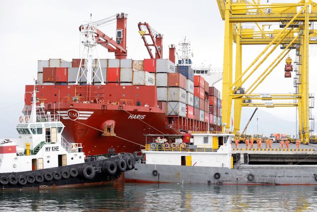 Containers are loaded onto a ship at Tien Sa port in Da Nang city