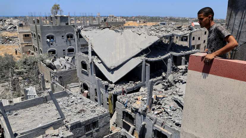 FILE PHOTO: Palestinians inspect houses destroyed during an Israeli military operation, in Deir al-Balah