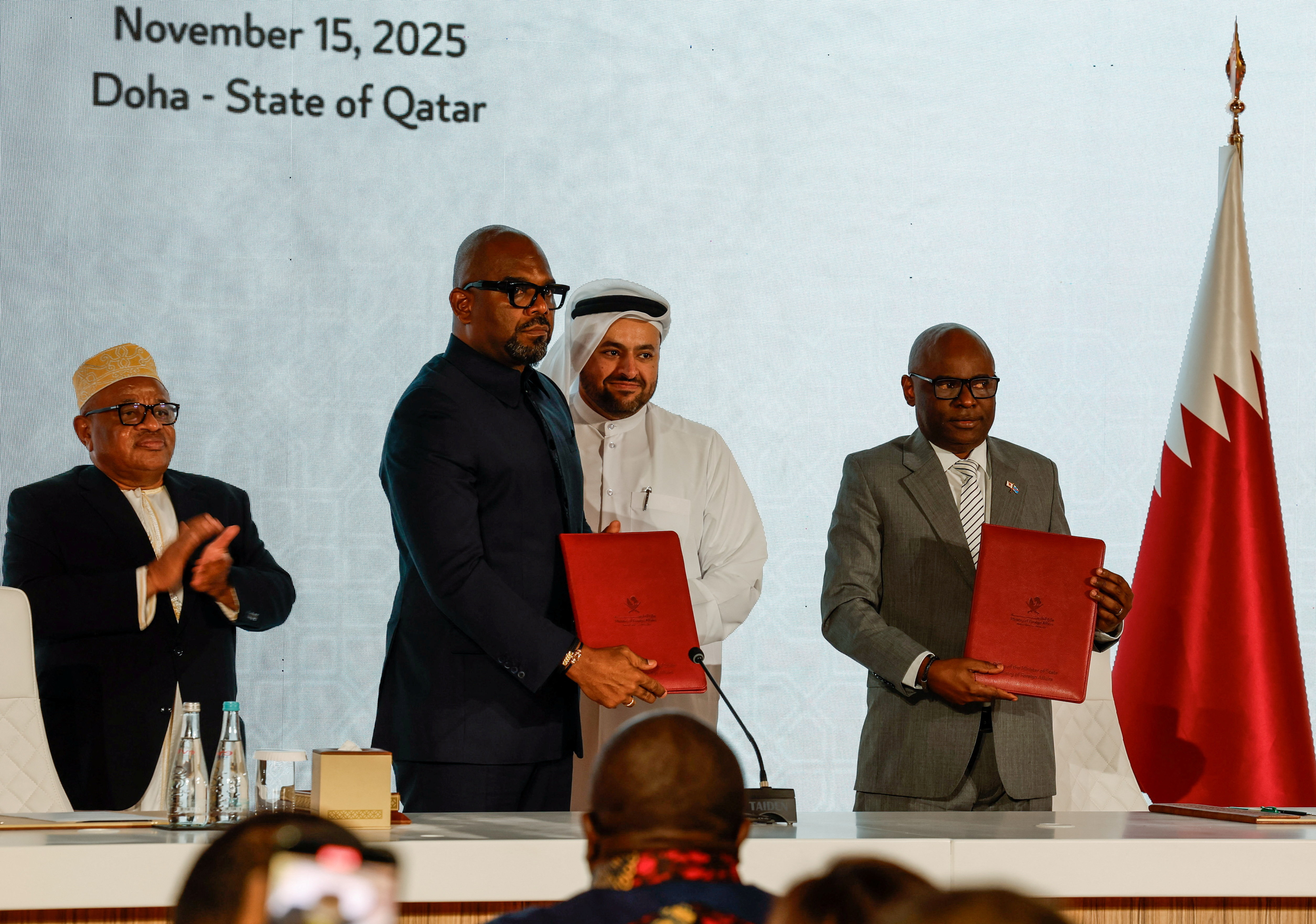 Representatives of the Democratic Republic of Congo and the M23 rebel group sign a framework agreement during a ceremony in Doha
