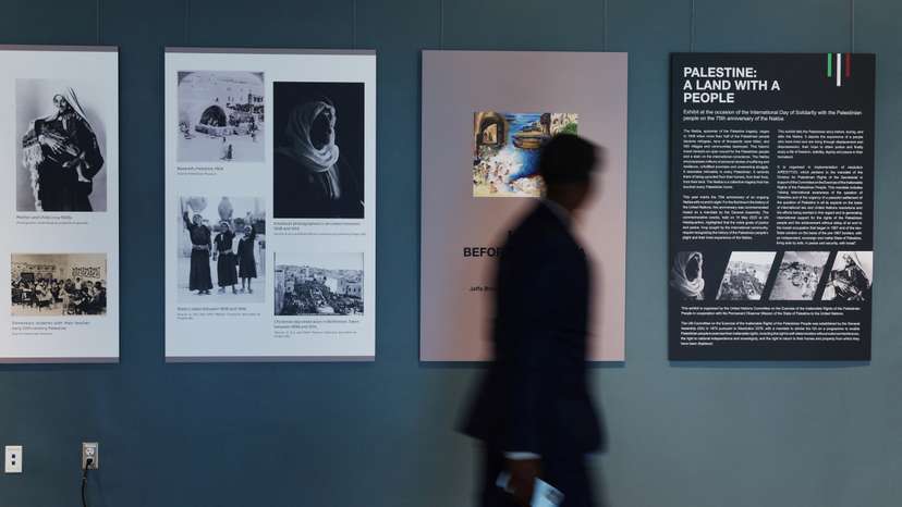A man walks by a photo installation, amid the ongoing conflict between Israel and the Palestinian Islamist group Hamas, inside United Nations headquarters in New York City,