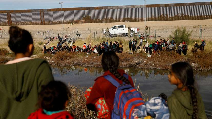 FILE PHOTO: Migrants seeking asylum in the United States gather on the banks of the Rio Bravo river, in Ciudad Juarez