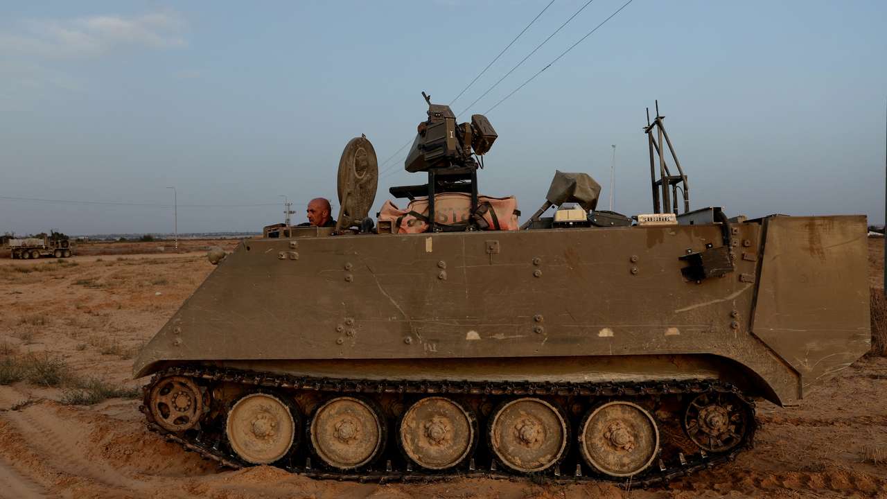 An Israeli solider drives an armored personnel carrier, as military operations continue in the southern Gaza city of Rafah, at an area outside Kerem Shalom, Israel