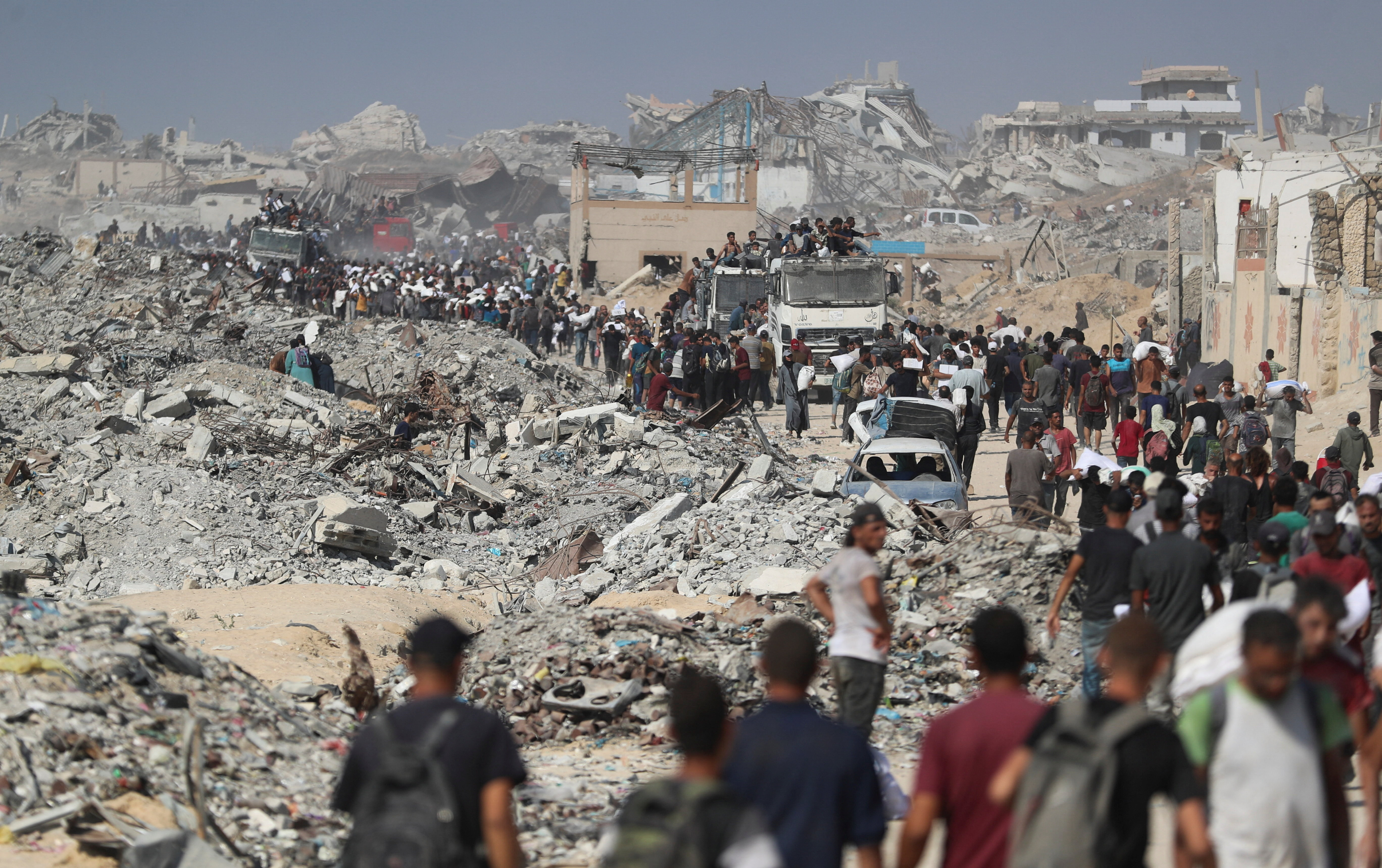 Palestinians carry aid supplies that entered Gaza through Israel, in Beit Lahia
