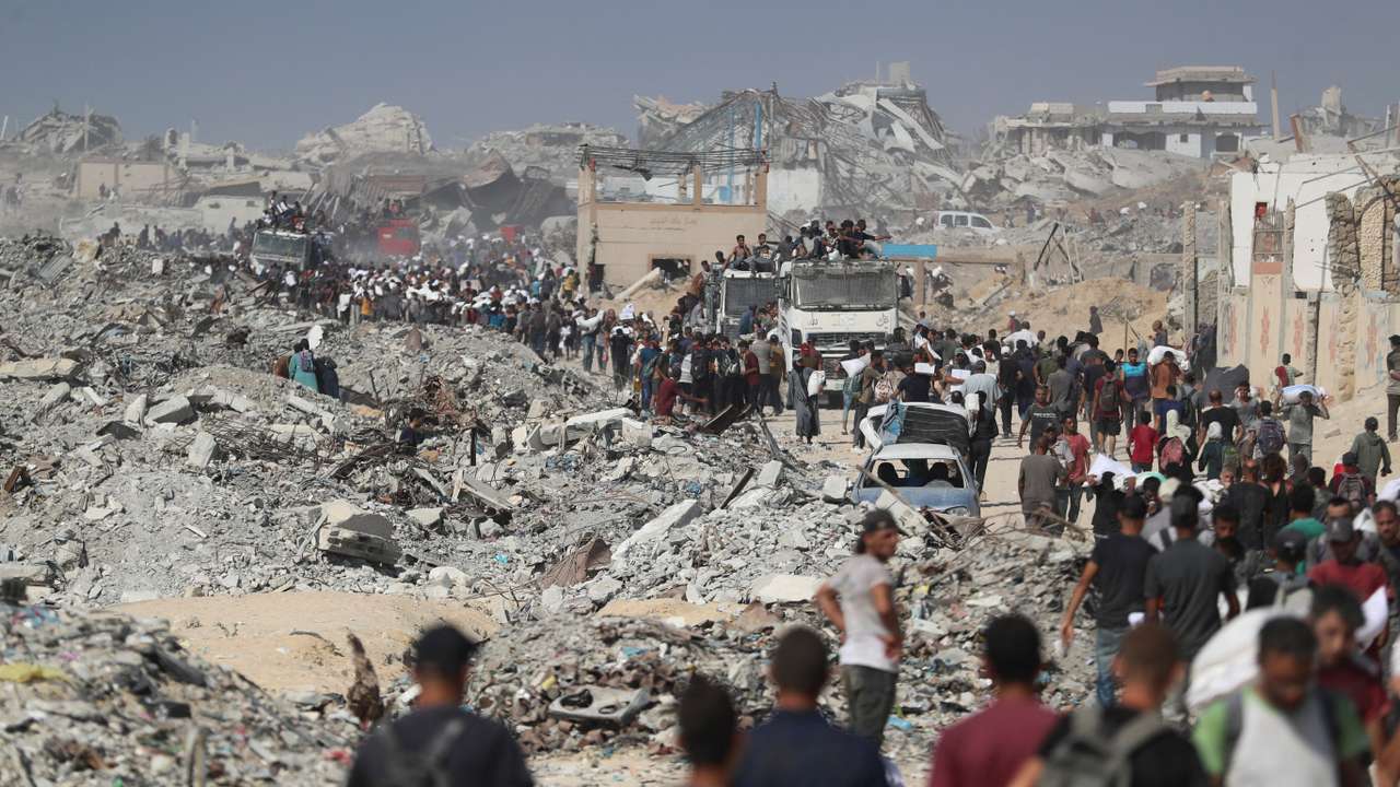 Palestinians carry aid supplies that entered Gaza through Israel, in Beit Lahia