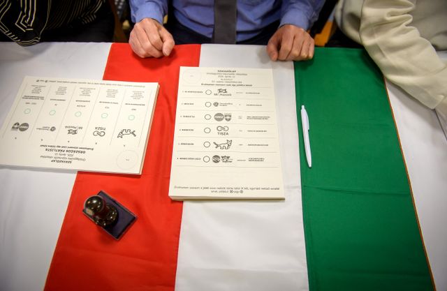 Ballot papers are placed on a Hungarian flag at a polling station in Budapest at the start of a general election in Hungary, on April 12, 2026. The vote could end Hungarian Prime Minister Viktor Orban's 16-year stint in power as the EU's longest serving current leader and a self-decribed "thorn" in the bloc's side. (Photo by Ferenc ISZA / AFP)
