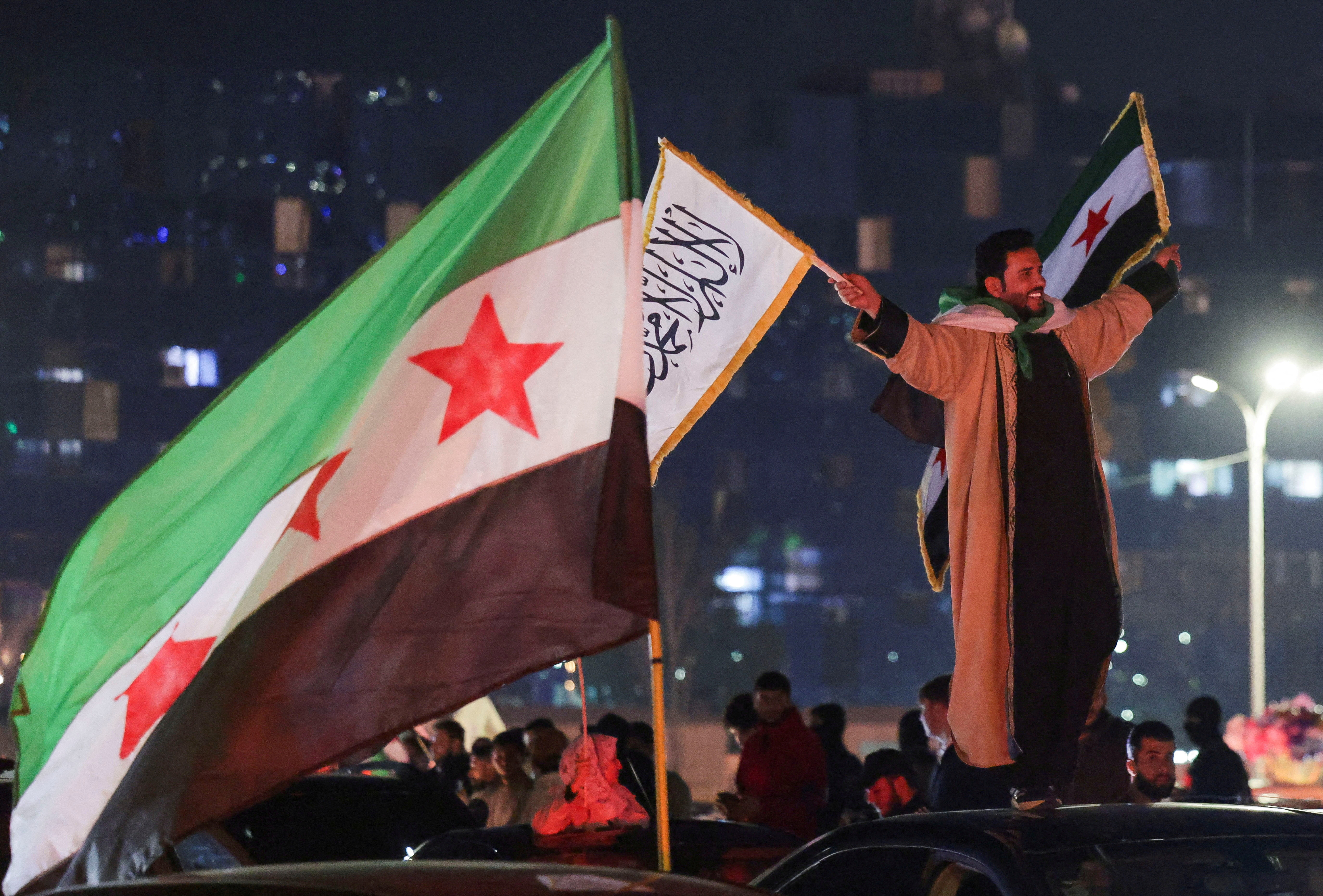 FILE PHOTO: People celebrate after the SDF has signed a deal agreeing to integrate into Syria's new state institutions, in Damascus