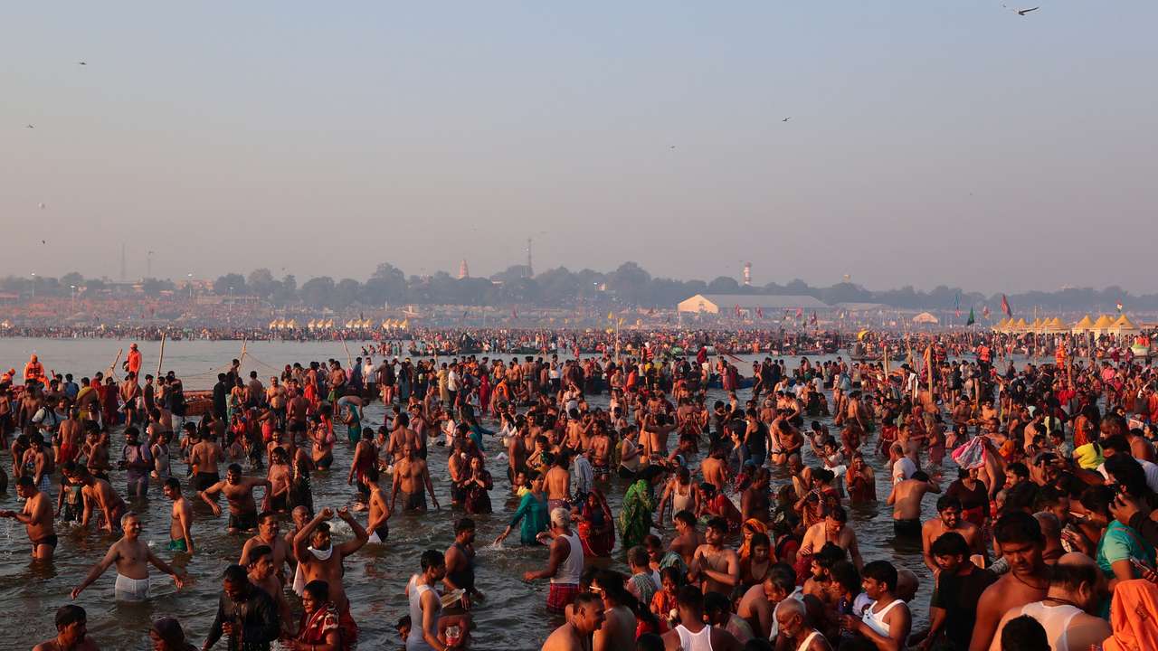 Devotees take a dip at Sangam during "Maha Kumbh Mela" in Prayagraj