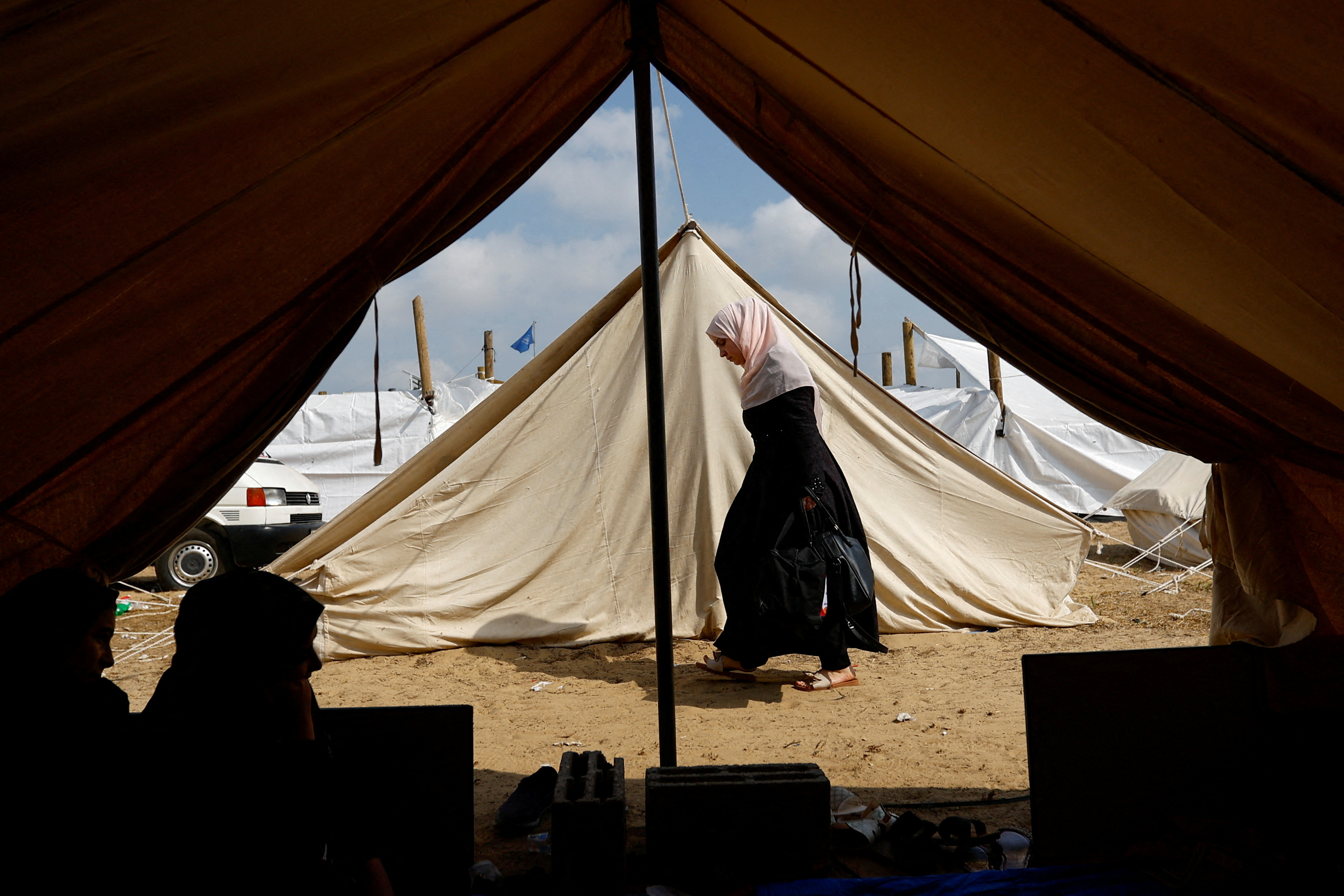FILE PHOTO: Palestinians take shelter in a tent camp at a United Nations-run centre in Khan Younis