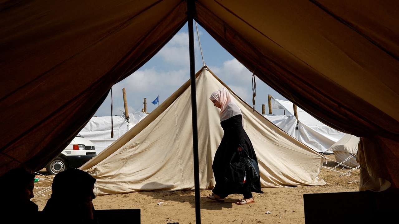 FILE PHOTO: Palestinians take shelter in a tent camp at a United Nations-run centre in Khan Younis