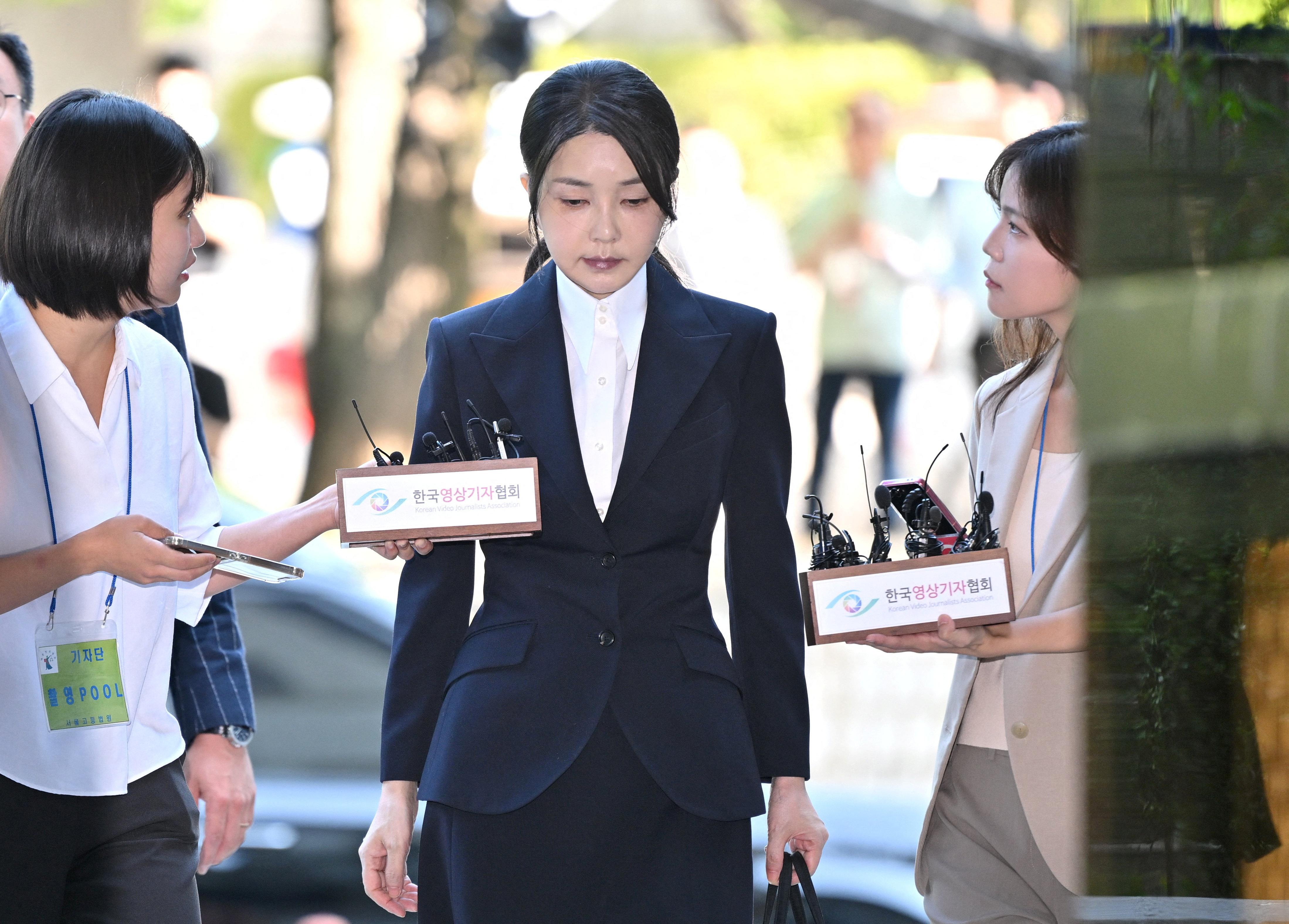 South Korea's former first lady Kim Keon Hee arrives at a court to attend a hearing to review her arrest warrant, in Seoul