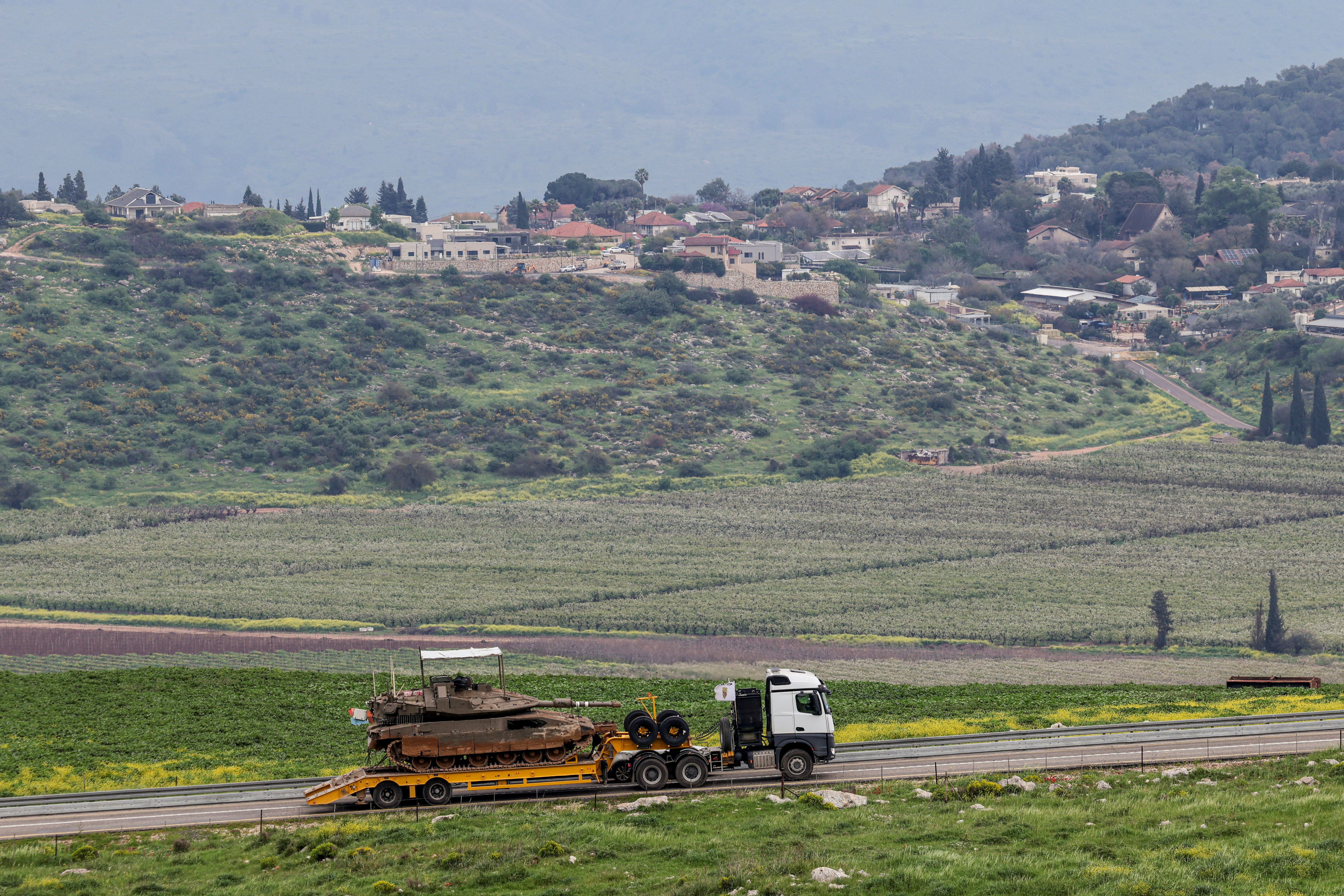 An Israeli tank is transported near the Israeli side of the border with Lebanon, amid escalating hostilities between Israel and Hezbollah, as the U.S.-Israeli conflict with Iran continues