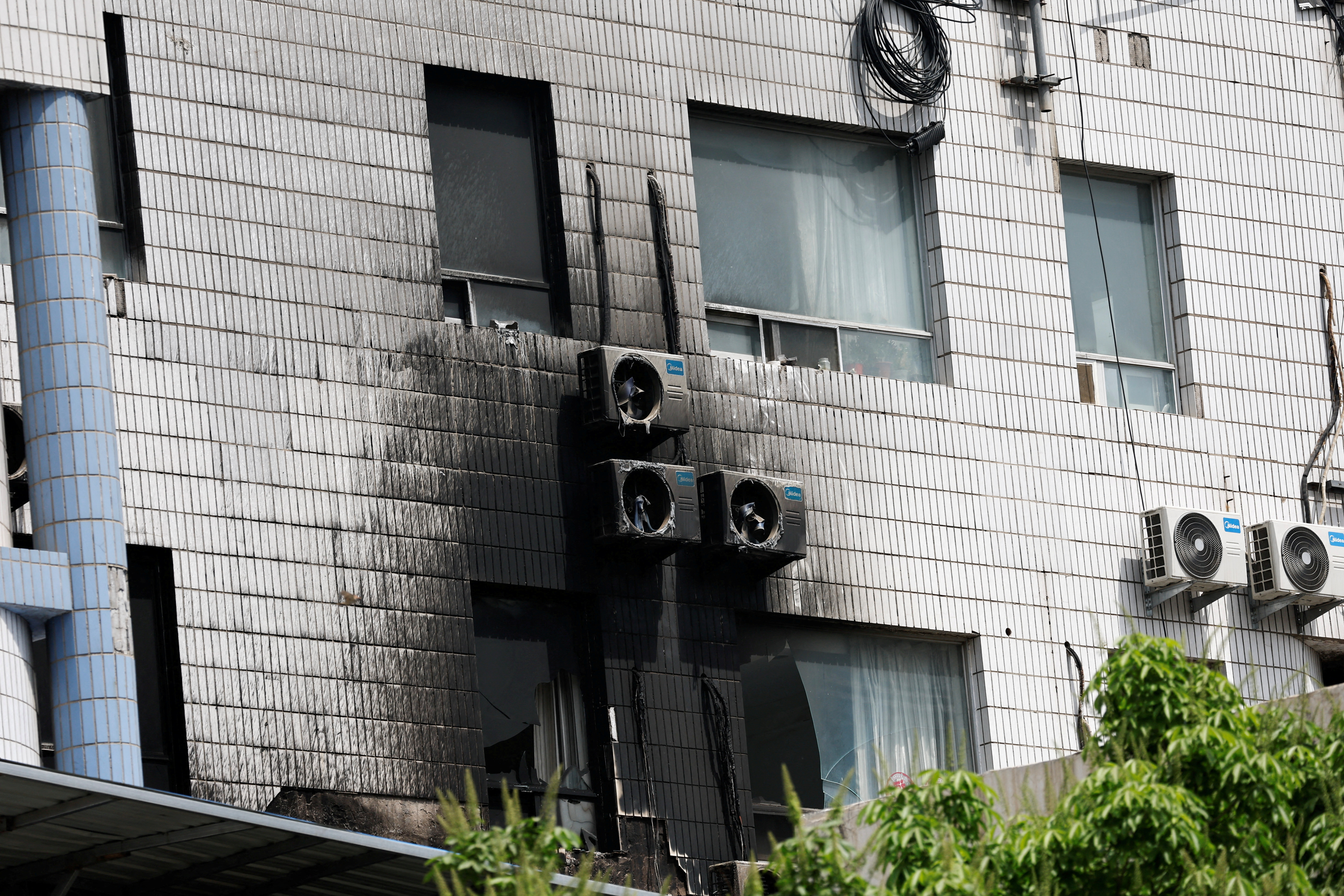 FILE PHOTO: Damaged windows and external air-conditioning fans are seen following a fire that occurred at the Changfeng Hospital, in Beijing