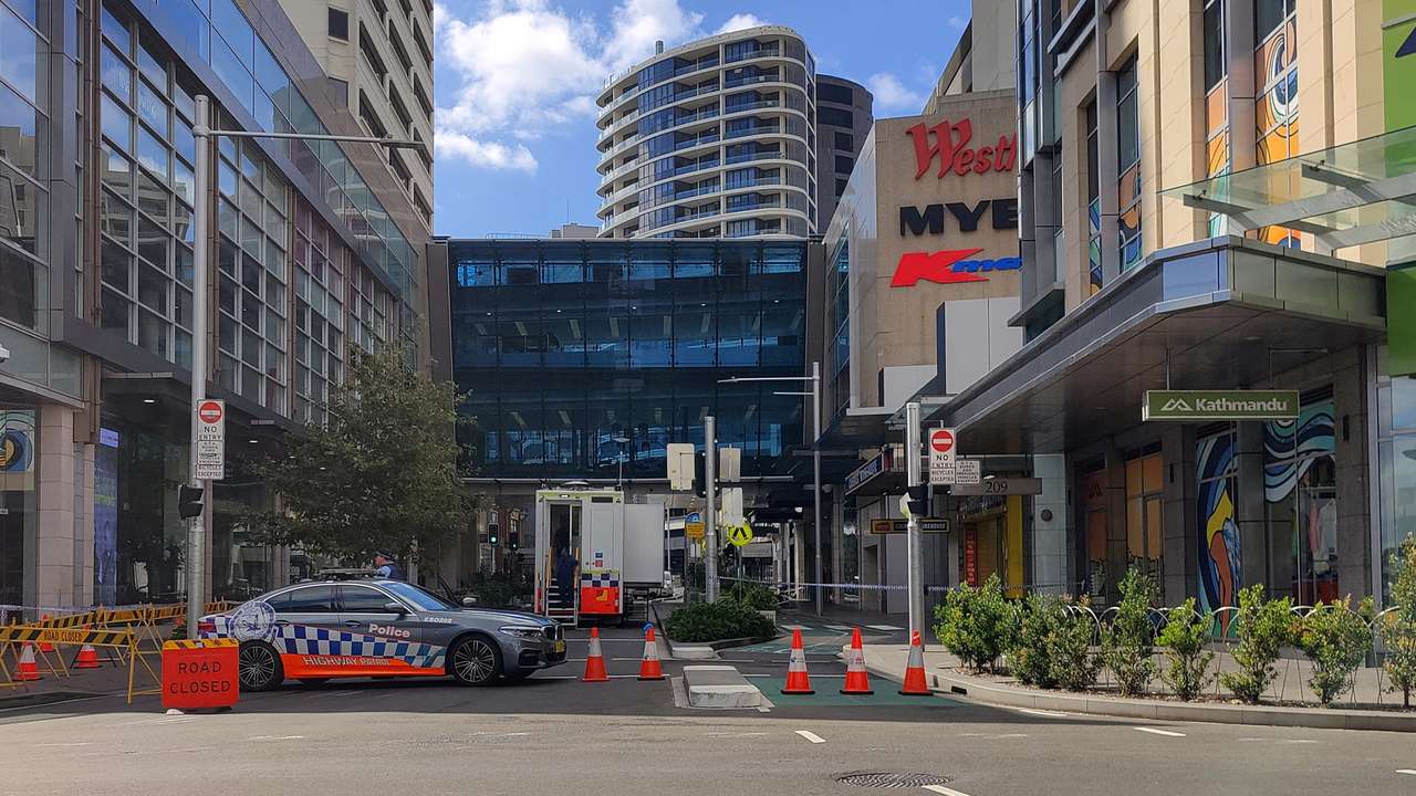 A view of a police car outside Westfield Bondi Junction as the mall remains under lockdown following Saturday’s stabbings in Sydney