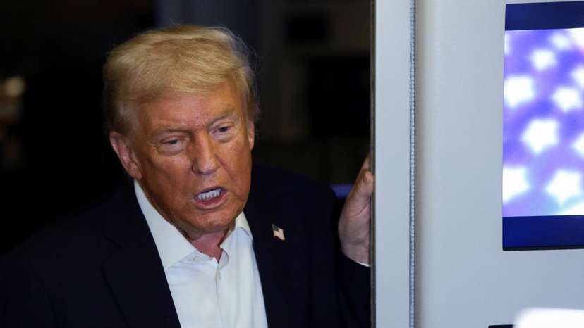 U.S. President Donald Trump speaks to the media aboard Air Force One