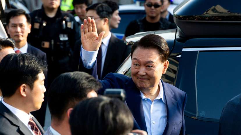 Ousted former South Korean President Yoon Suk Yeol waves to his supporters as he moves out of the presidential residence in Seoul