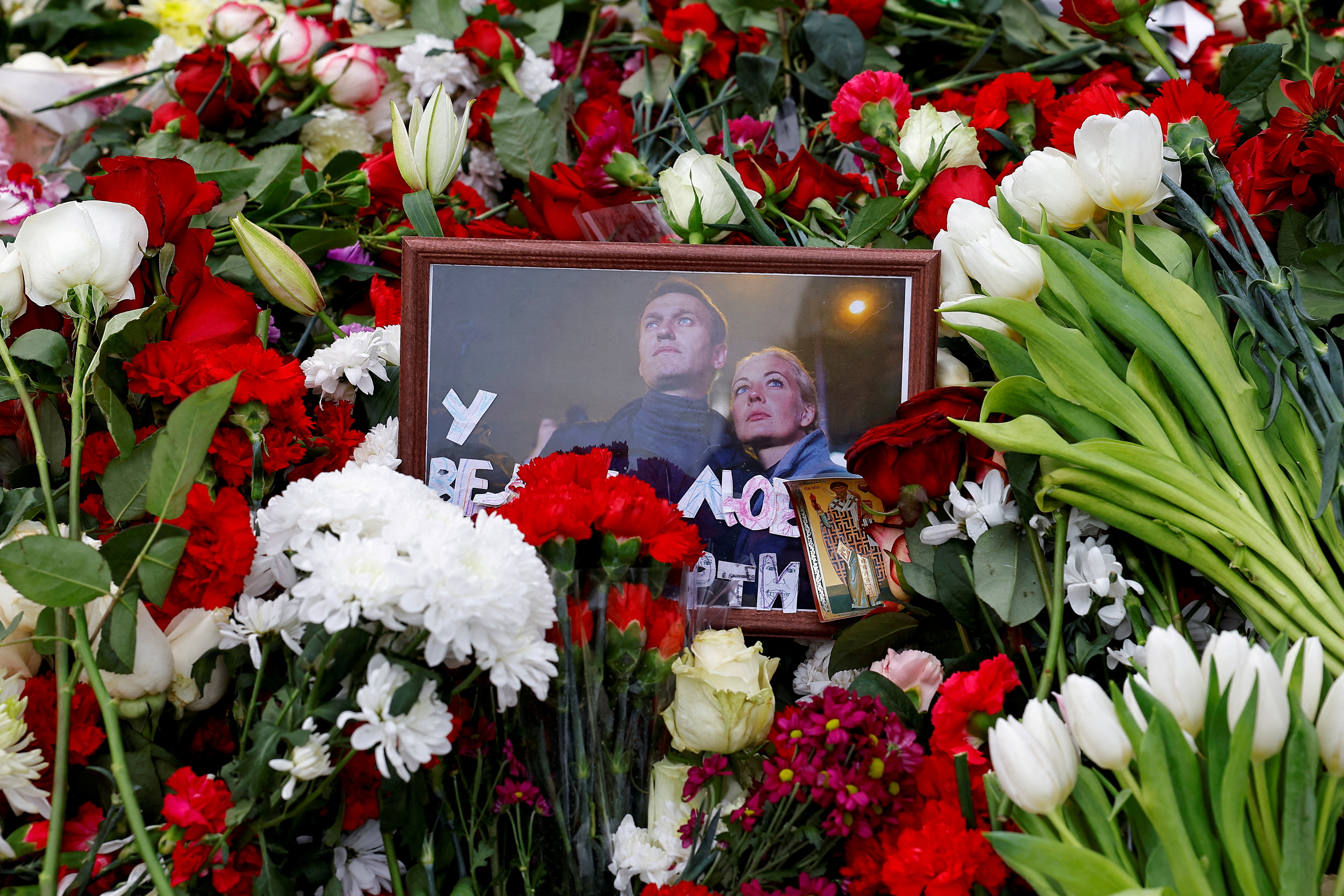 FILE PHOTO: Mourners come to grave of Russian opposition leader Alexei Navalny