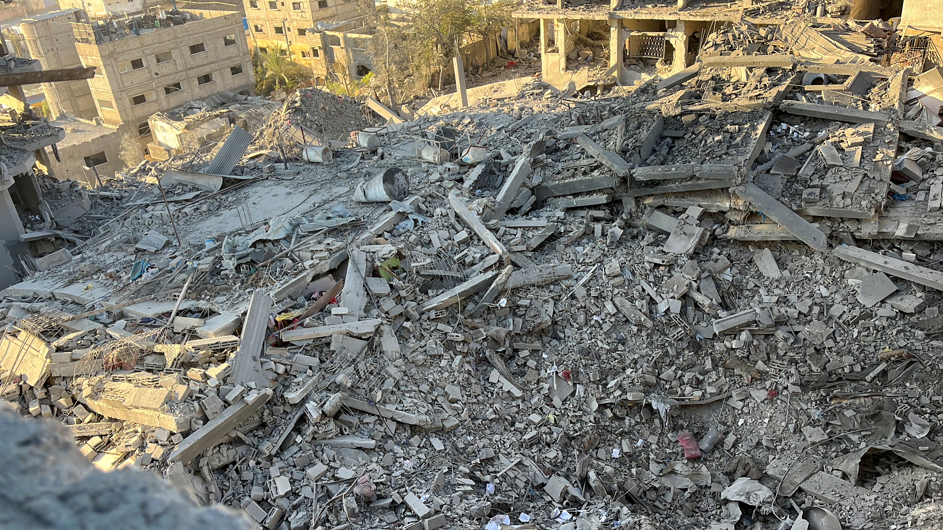 A multi-storey residential building lies in ruins following an Israeli strike, in Beit Lahiya in the northern Gaza Strip