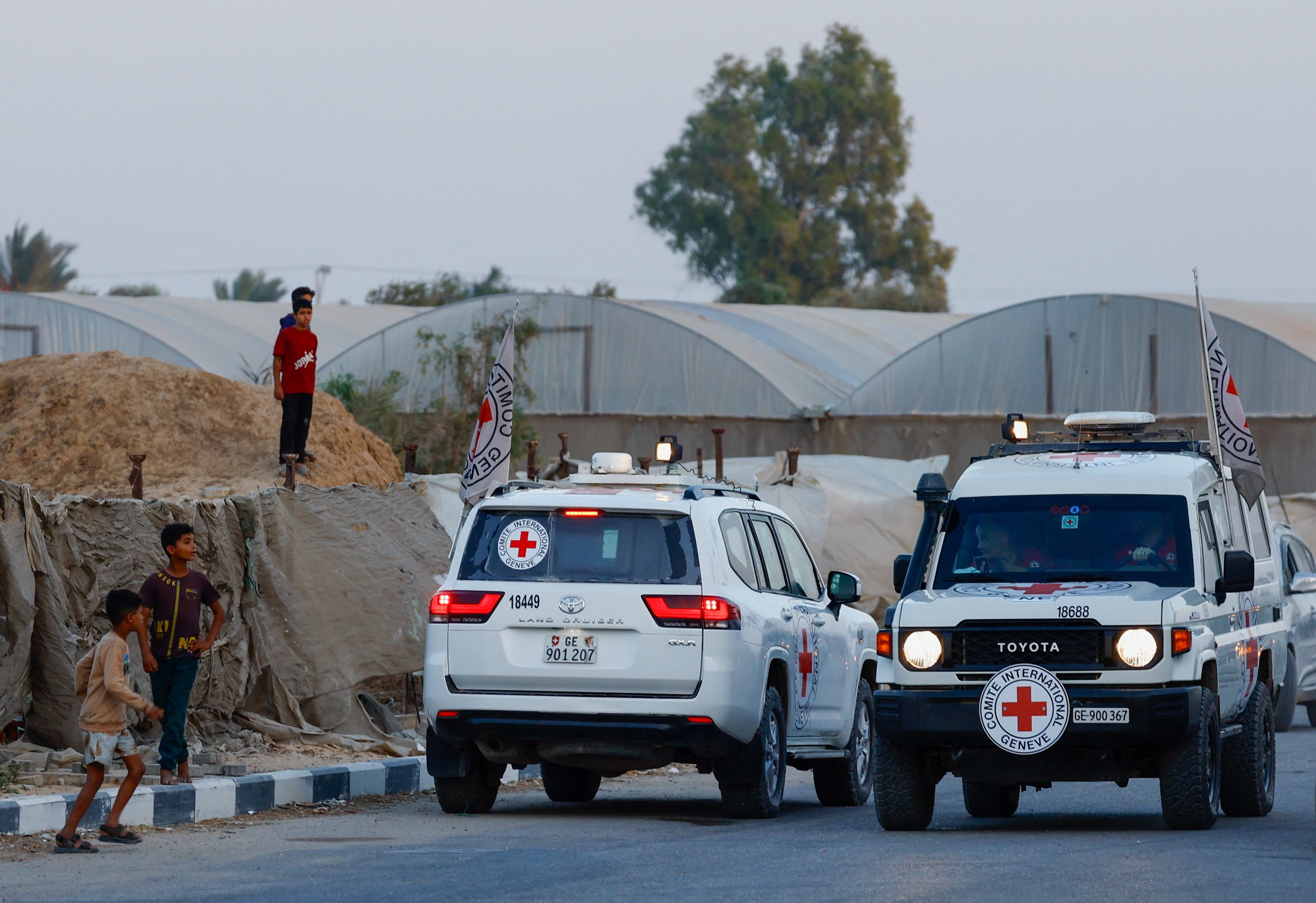 Red Cross transports bodies of two deceased hostages, kidnapped during October 7, 2023, attack on Israel by Hamas, after they were handed over by Hamas militants, in Deir Al-Balah