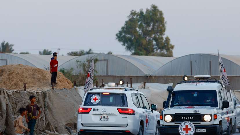 Red Cross transports bodies of two deceased hostages, kidnapped during October 7, 2023, attack on Israel by Hamas, after they were handed over by Hamas militants, in Deir Al-Balah