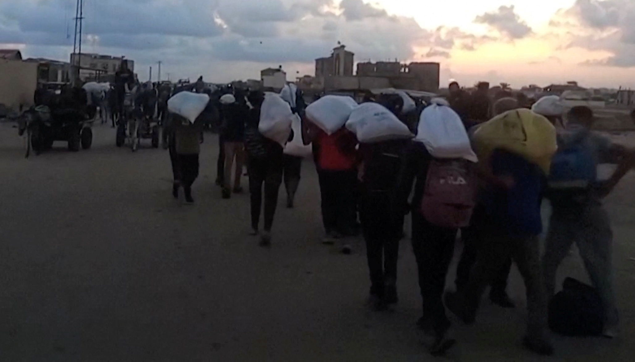 Palestinians carry aid supplies received from the U.S.-backed Gaza Humanitarian Foundation, in Rafah