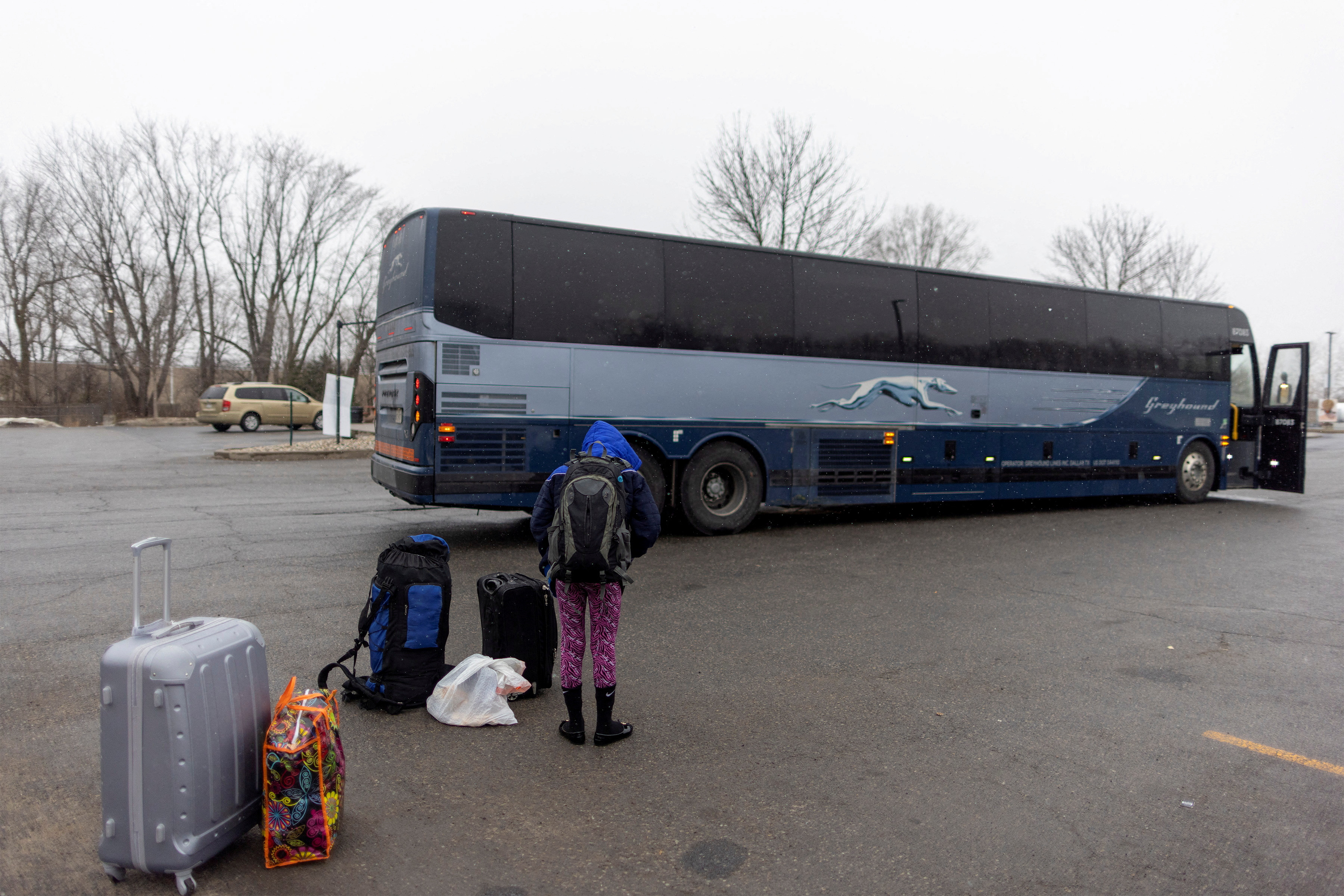 FILE PHOTO: People wait for transport to cross into Canada at Roxham Road, in Plattsburgh