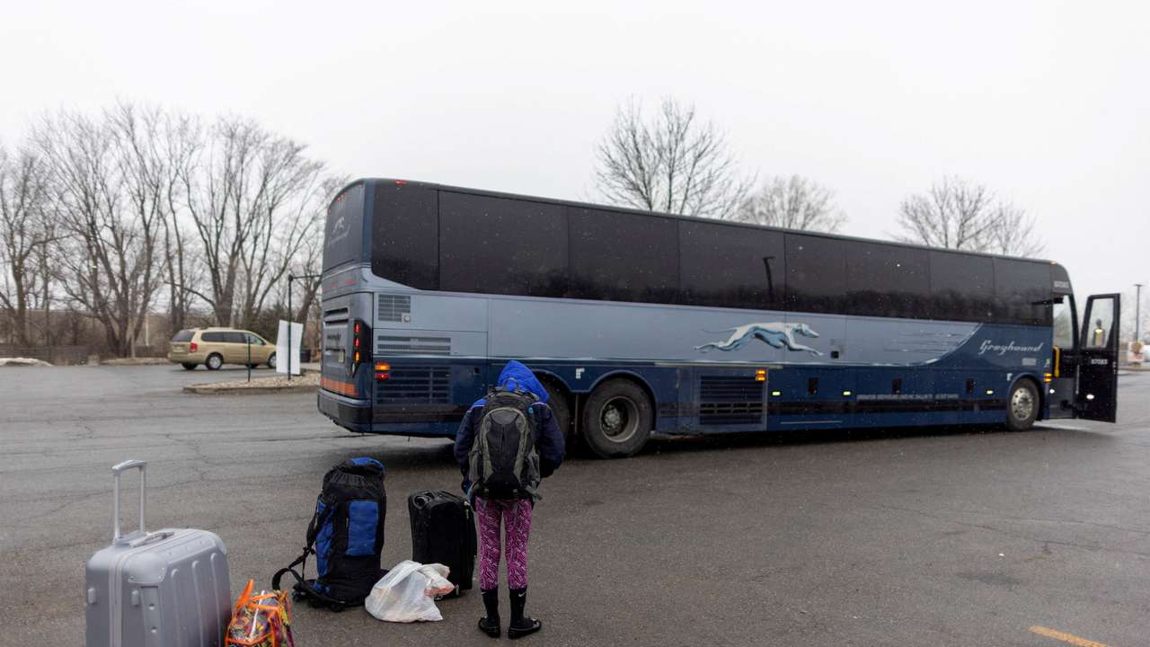 FILE PHOTO: People wait for transport to cross into Canada at Roxham Road, in Plattsburgh