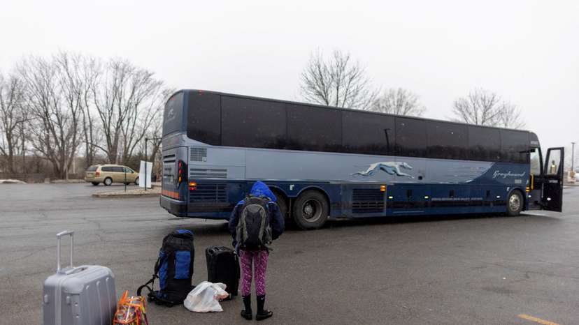 FILE PHOTO: People wait for transport to cross into Canada at Roxham Road, in Plattsburgh