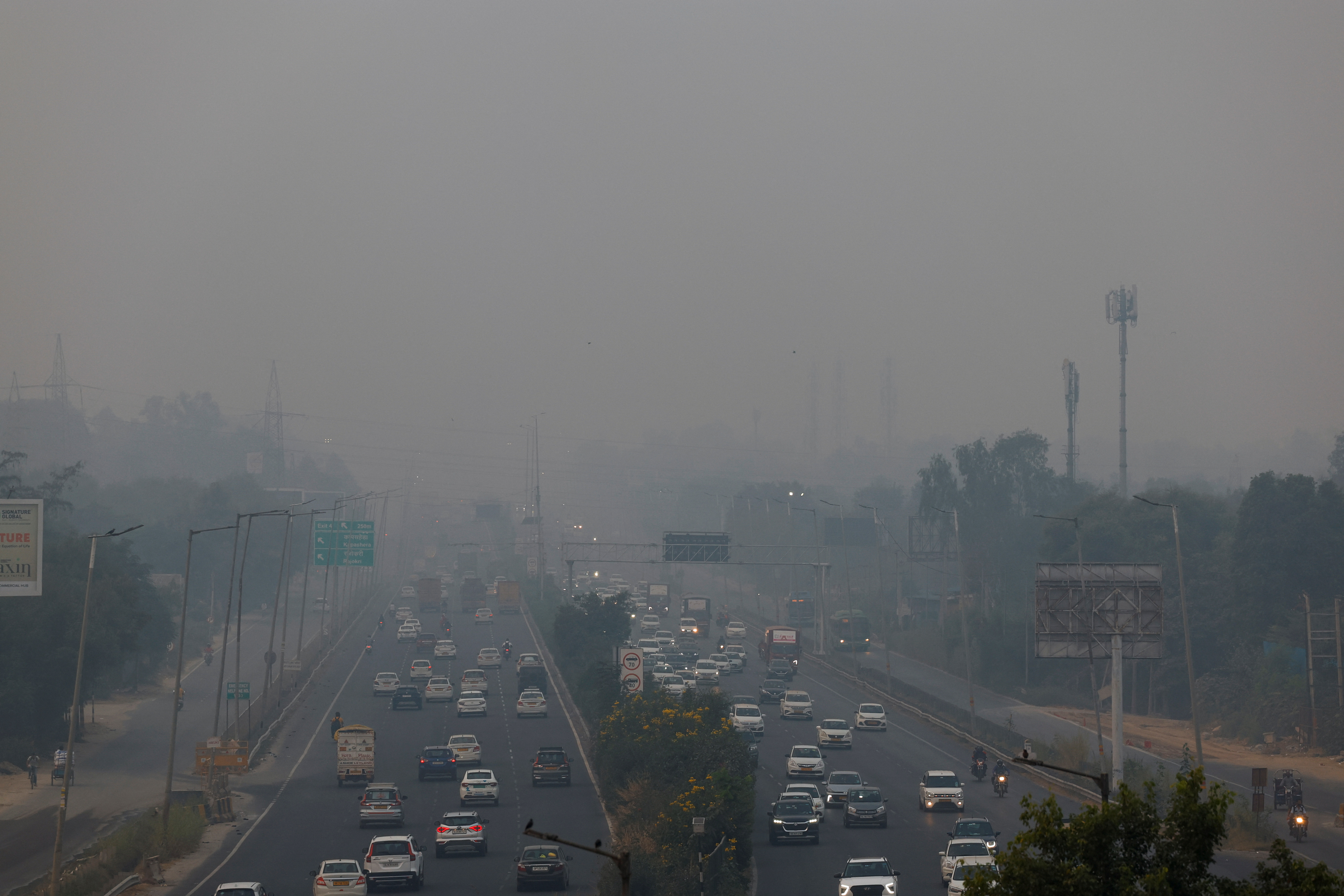 Vehicles ride past on an expressway on a smoggy morning in New Delhi