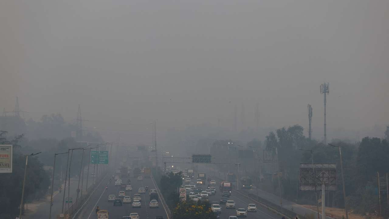 Vehicles ride past on an expressway on a smoggy morning in New Delhi