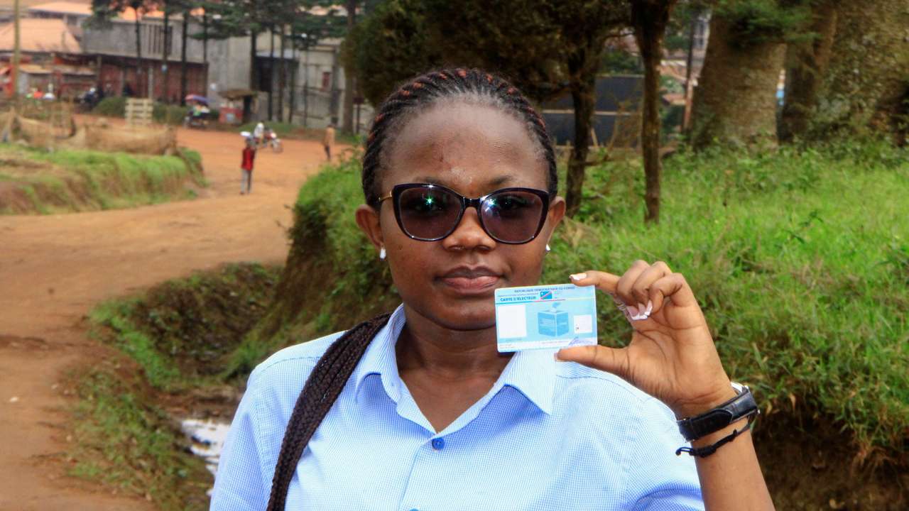 Stephanie Mbafumoja, a Congolese law student holds her voter identity card in L'avenue de L'itav in Butembo