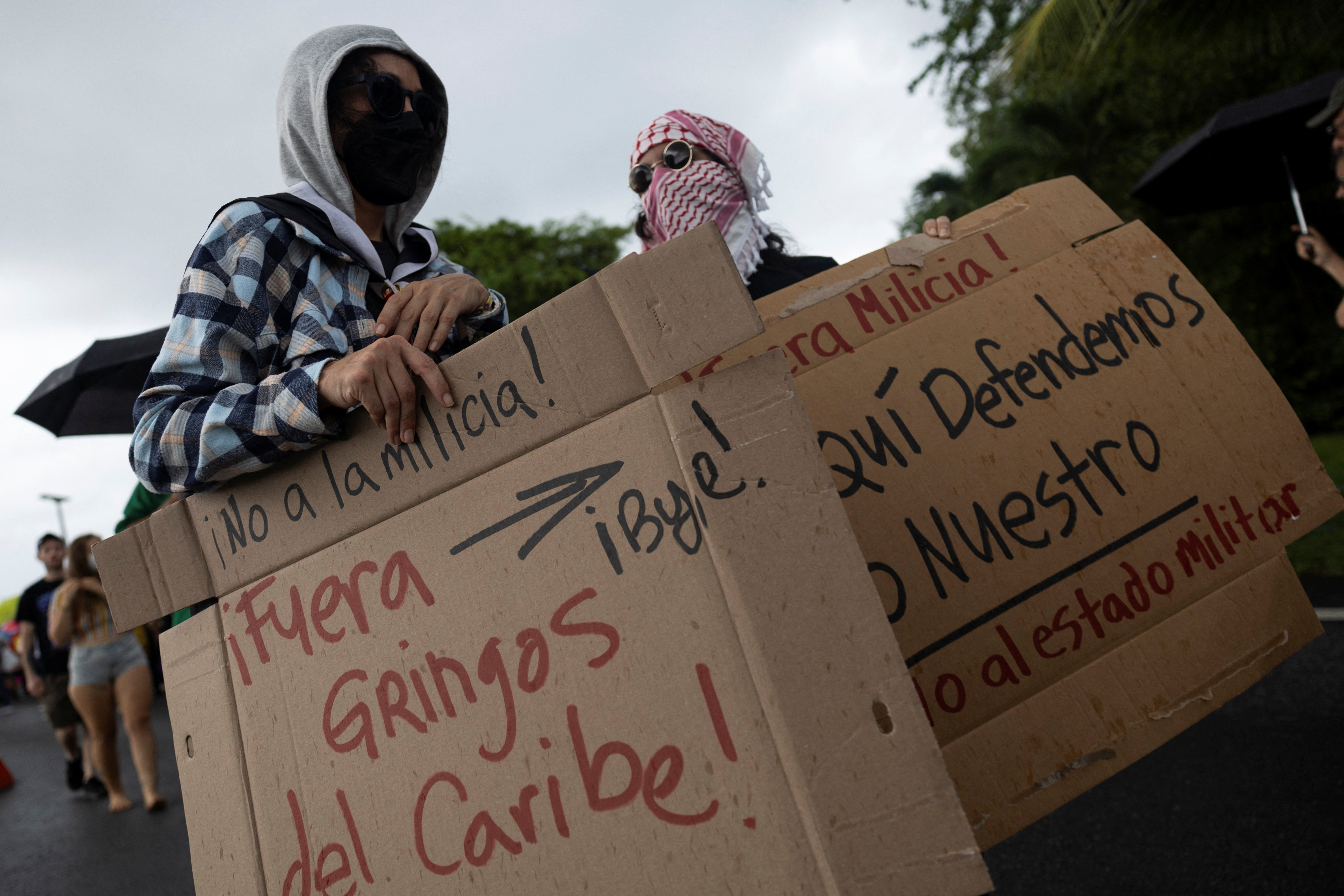 People rally against military exercises in front of the Muniz Puerto Rico Air National Guard Base, in Carolina