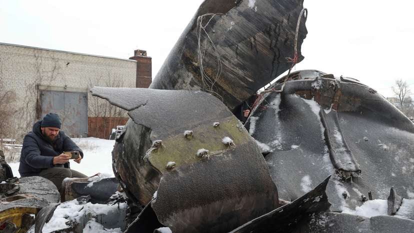 FILE PHOTO: A man photographs parts of an unidentified missile, which Ukrainian authorities believe to be made in North Korea, in Kharkiv
