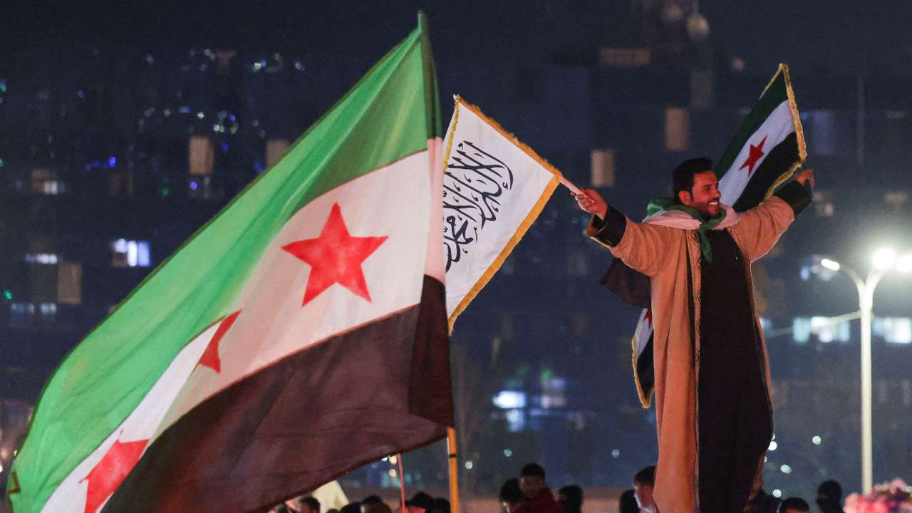 FILE PHOTO: People celebrate after the SDF has signed a deal agreeing to integrate into Syria's new state institutions, in Damascus