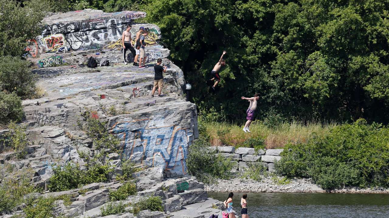 People jump into the Ottawa River on a hot summer day in Gatineau