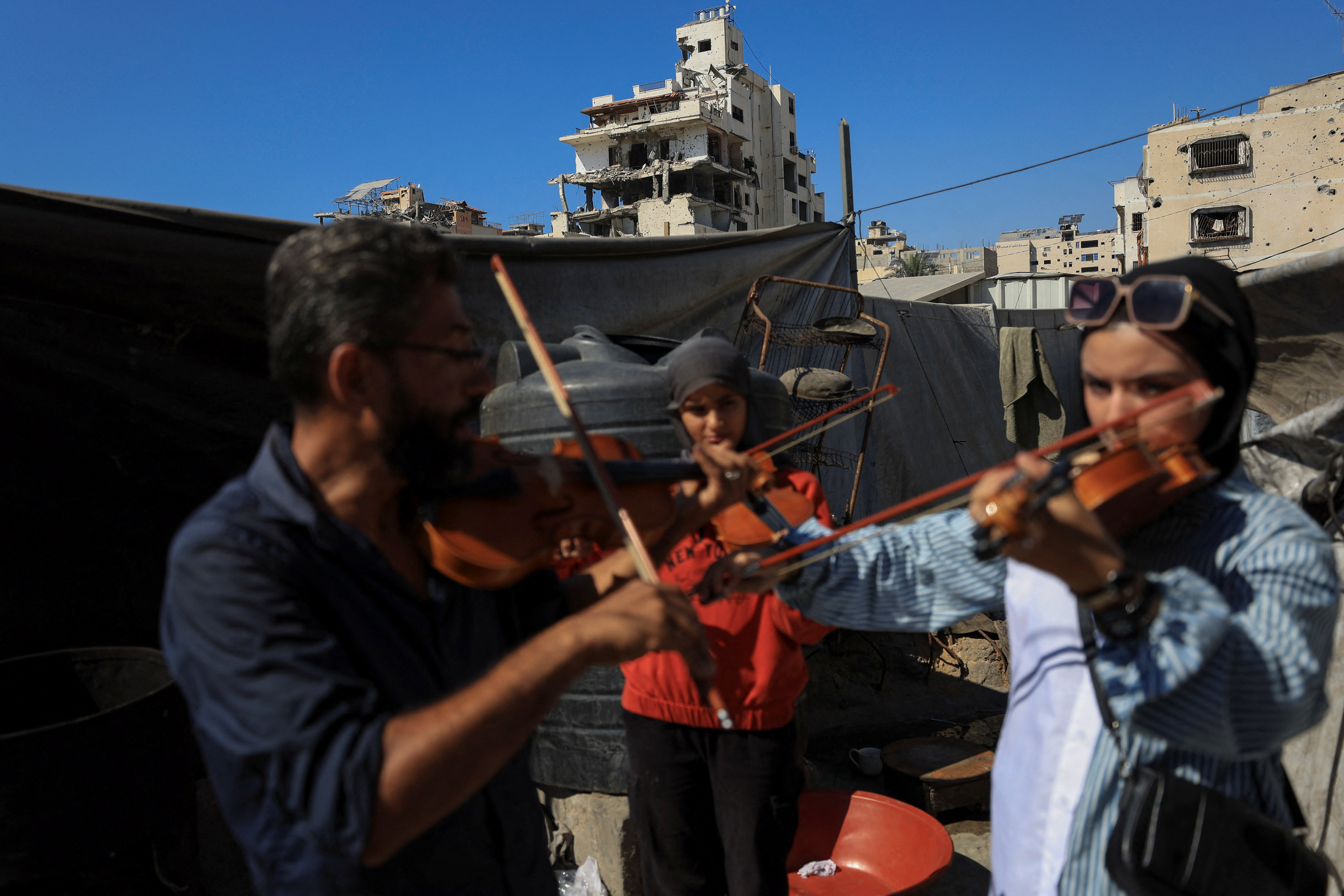 The Wider Image: Gaza's young musicians sing and play in the ruins of war