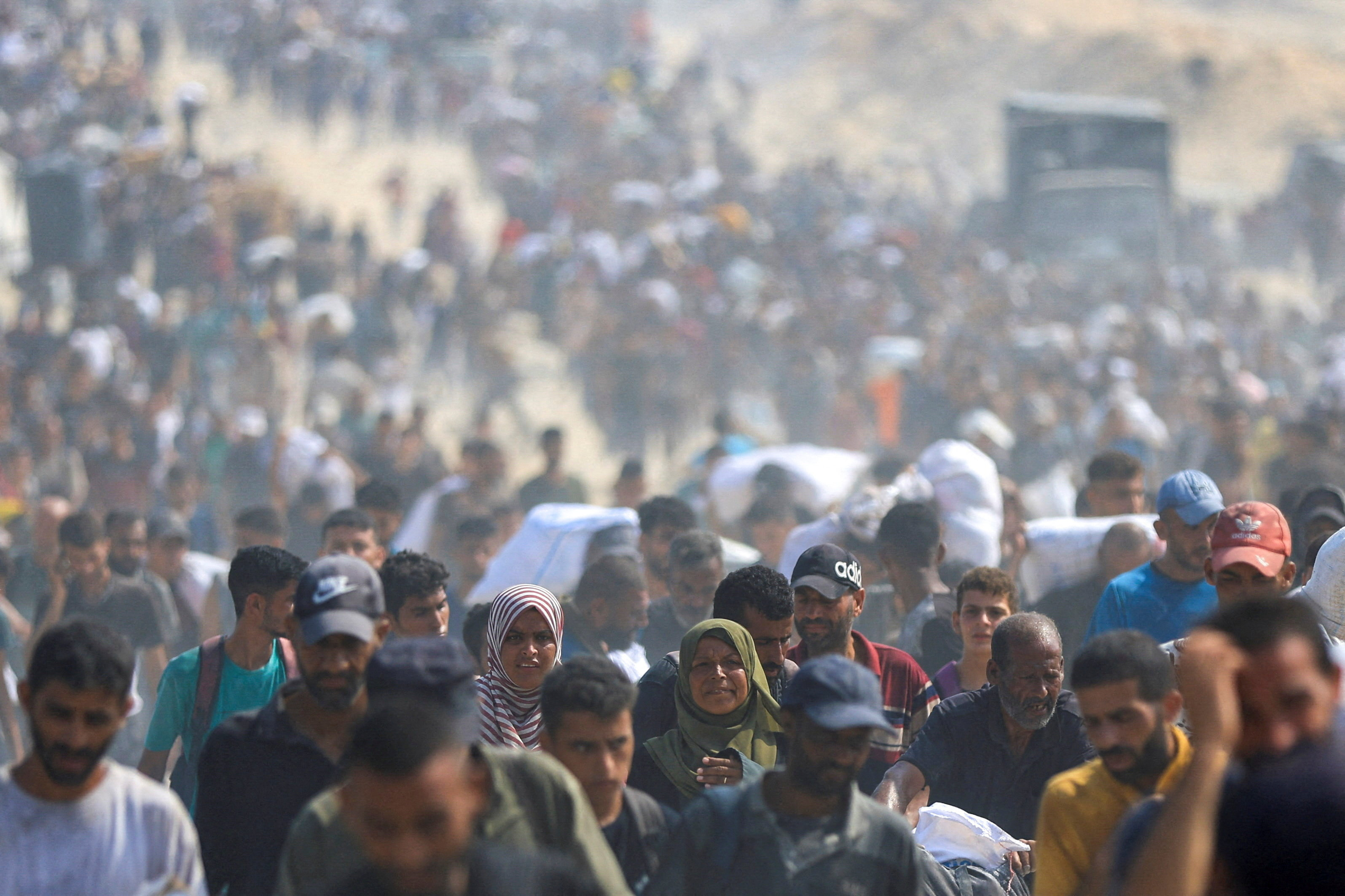 Palestinians seek aid supplies from trucks that entered Gaza through Israel, in Beit Lahia, in the northern Gaza Strip