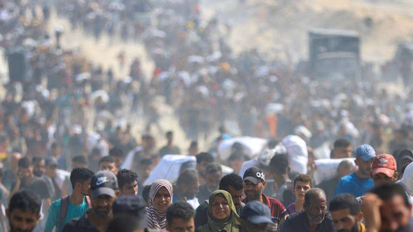 Palestinians seek aid supplies from trucks that entered Gaza through Israel, in Beit Lahia, in the northern Gaza Strip