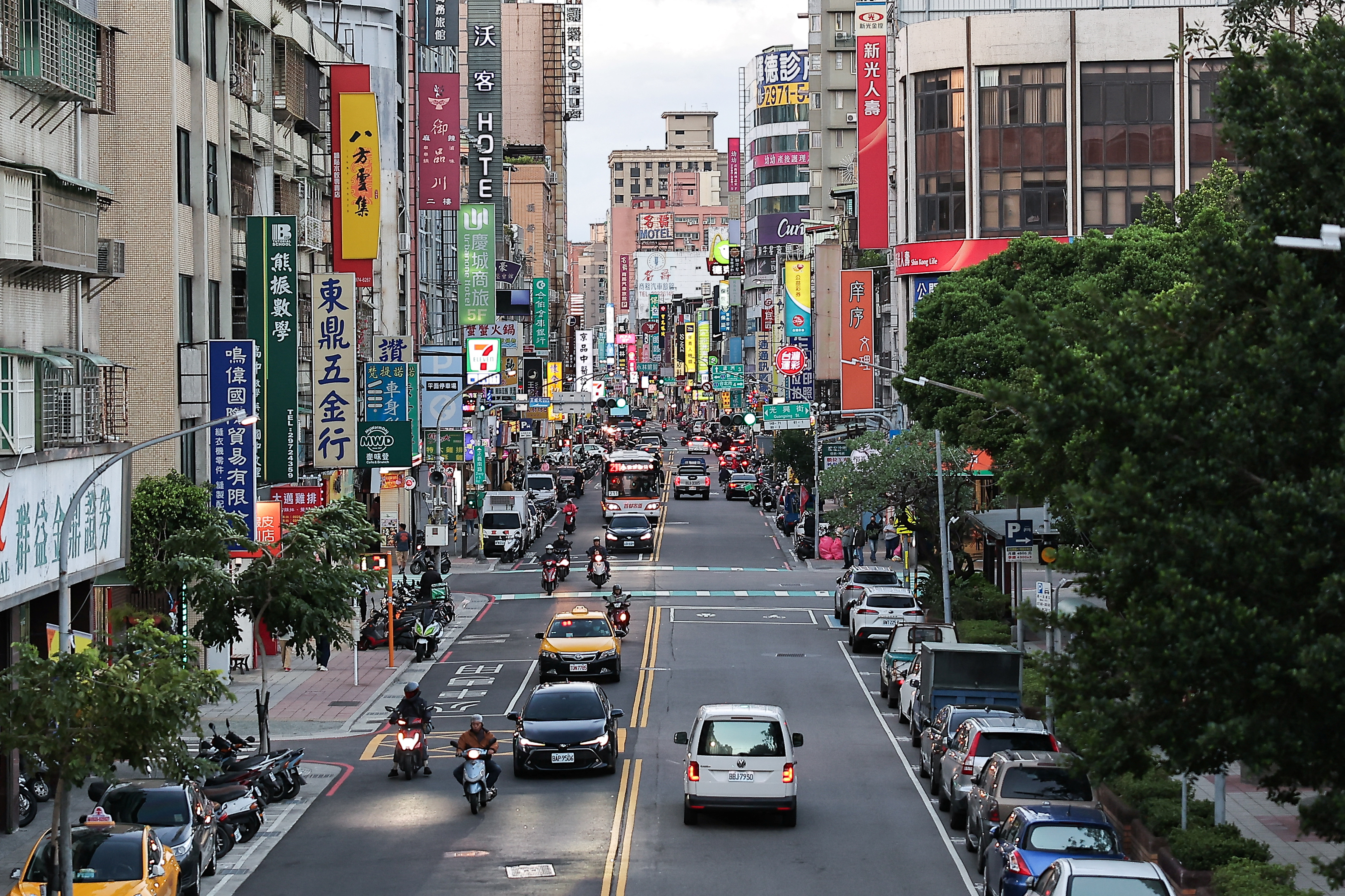 Vehicles drive on a street, at New Taipei city