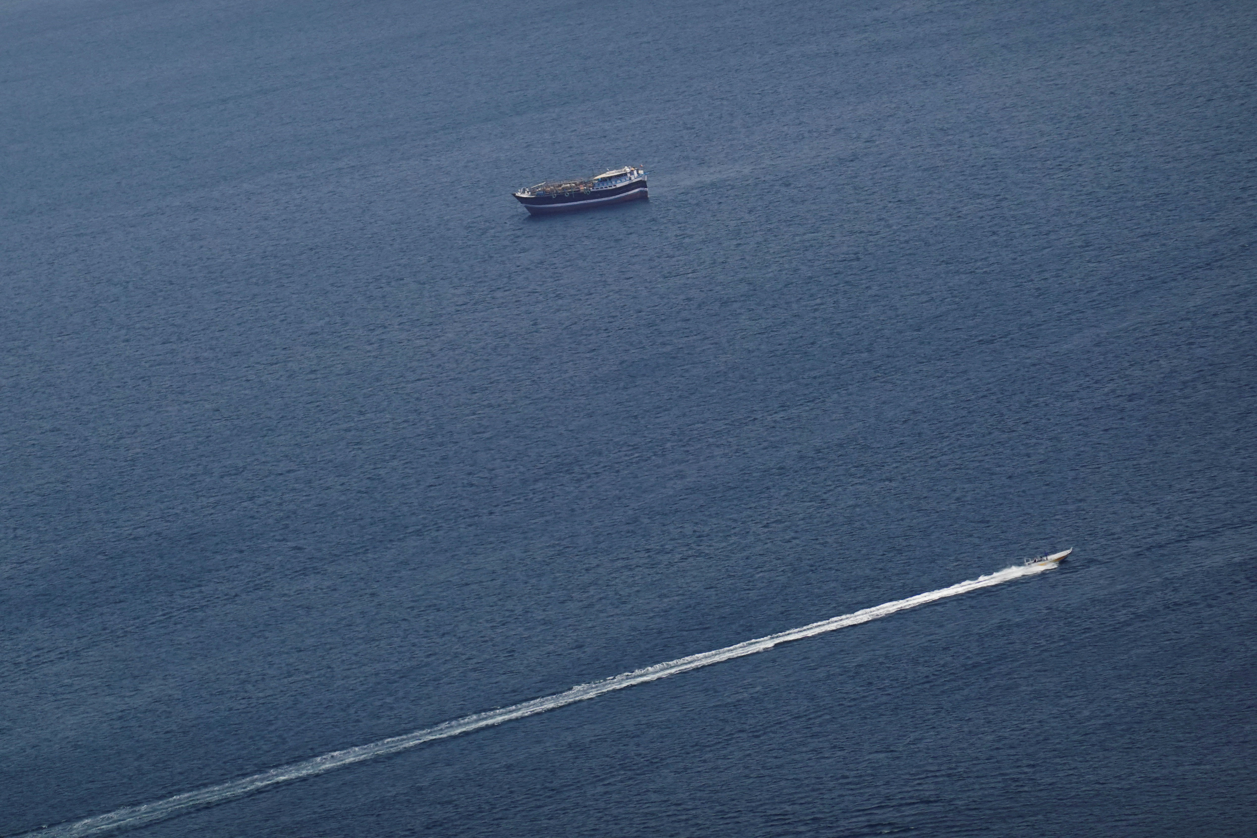 FILE PHOTO: Boats in the Strait of Hormuz amid the U.S.-Israeli conflict with Iran, as seen from Musandam