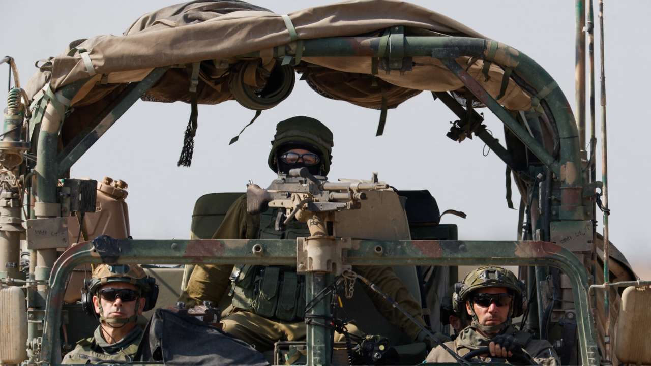 A military vehicle maneuvres near the Israel-Gaza border
