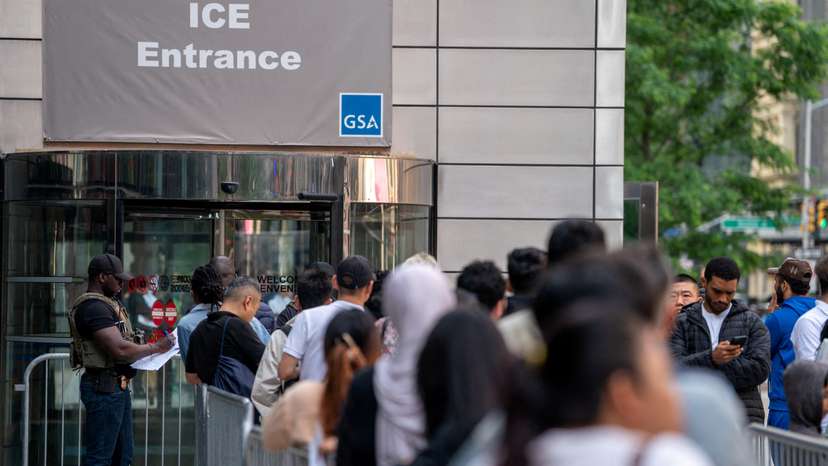 FILE PHOTO: An ICE agent speaks to people lined up to enter the U.S. Immigration Court, in Manhattan