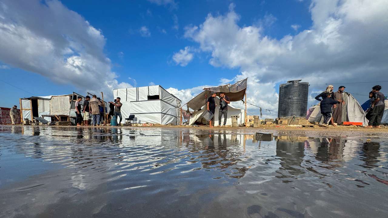 Displaced Palestinians gather as they shelter in a tent camp which was flooded following rainfall, amid the Israel-Hamas conflict, in Khan Younis, in the southern Gaza Strip