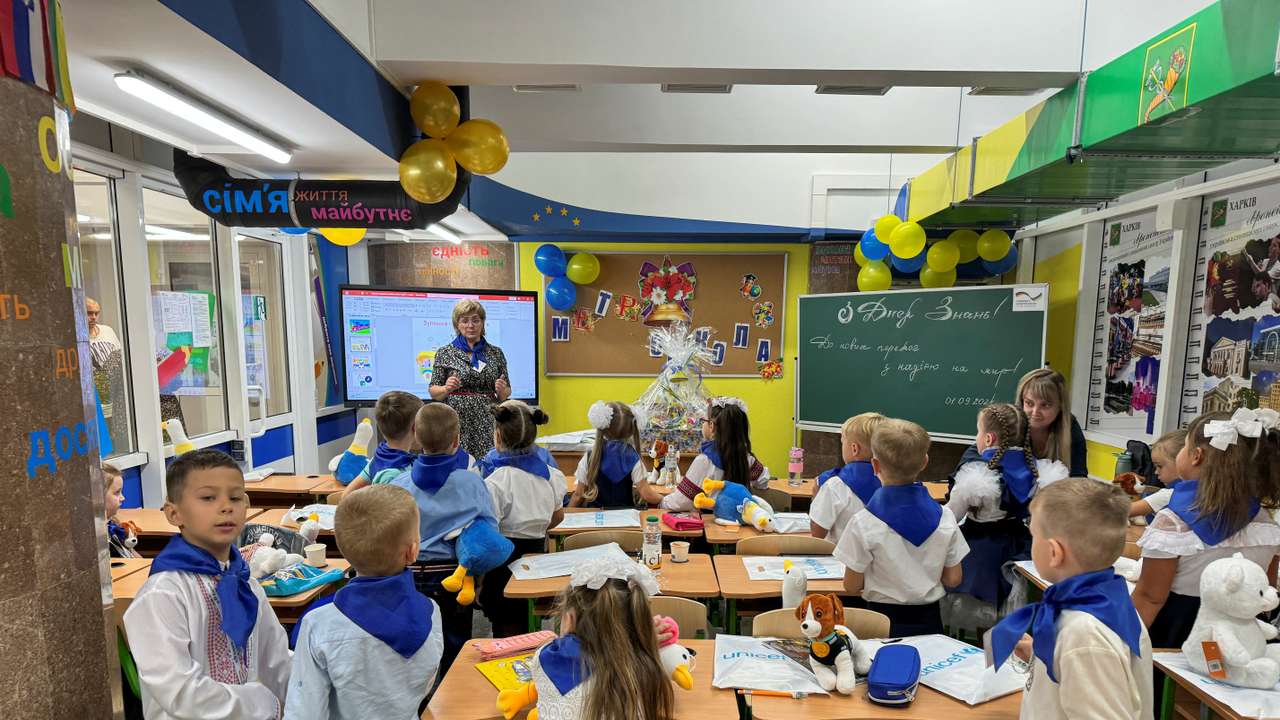 Teachers conduct a lesson for students on the first day of a school year at an underground school in Kharkiv