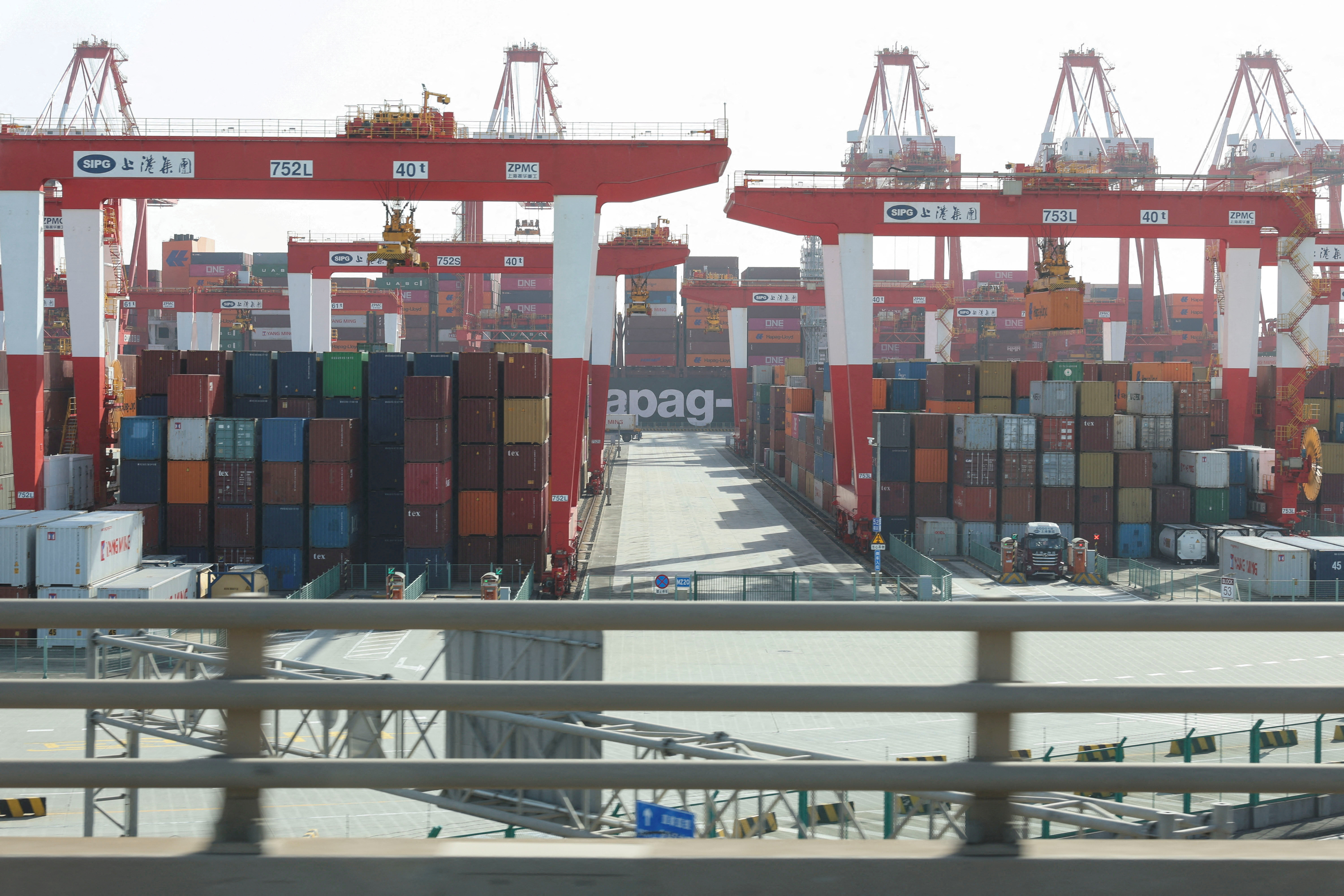 FILE PHOTO: Gantry cranes stand near shipping containers at Yangshan Port outside of Shanghai