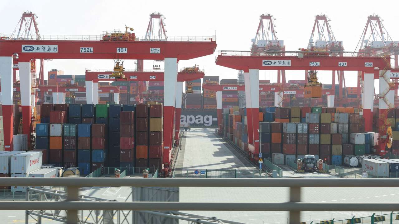 FILE PHOTO: Gantry cranes stand near shipping containers at Yangshan Port outside of Shanghai