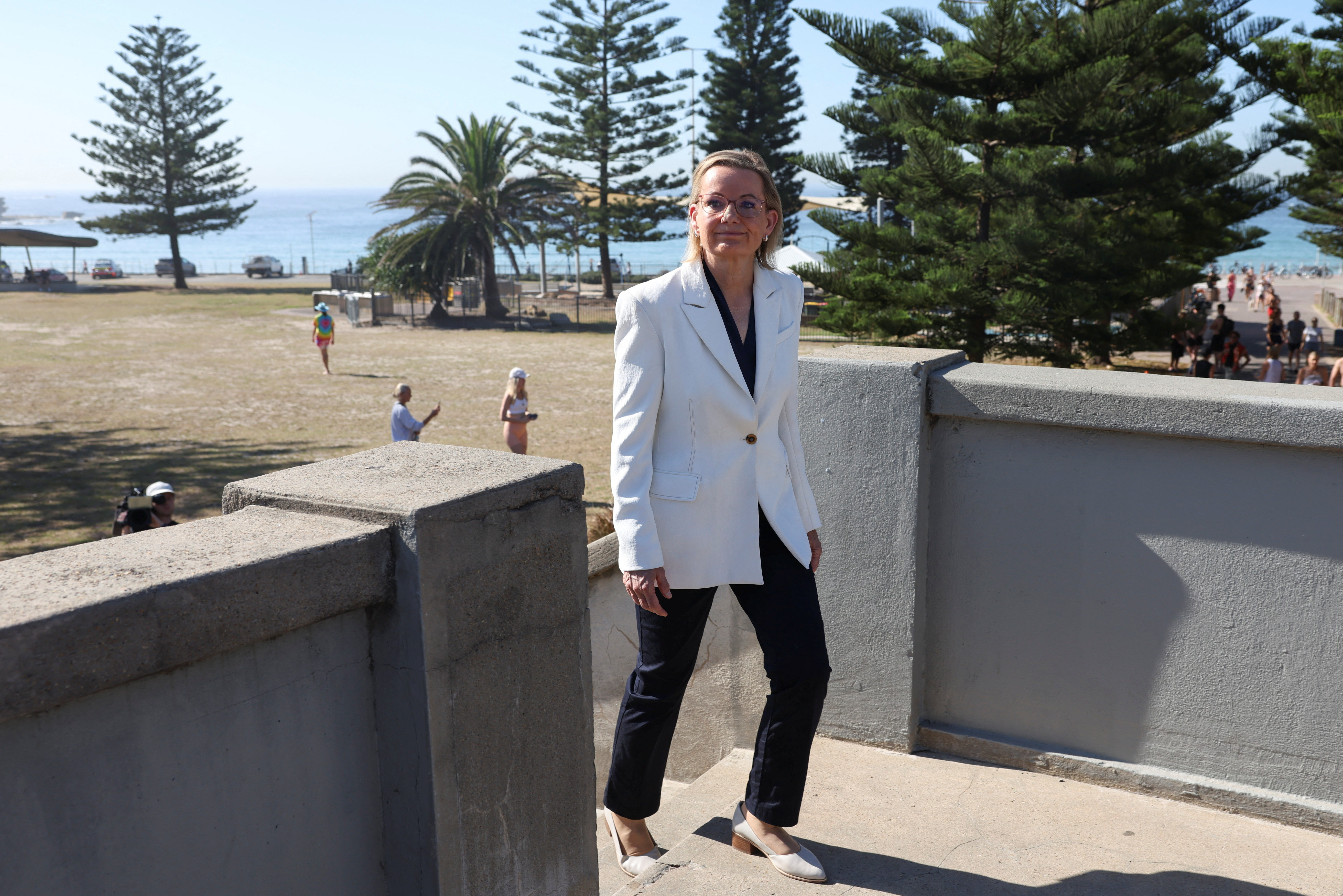 People visit the crime scene after it was reopened following the mass shooting at Bondi Beach