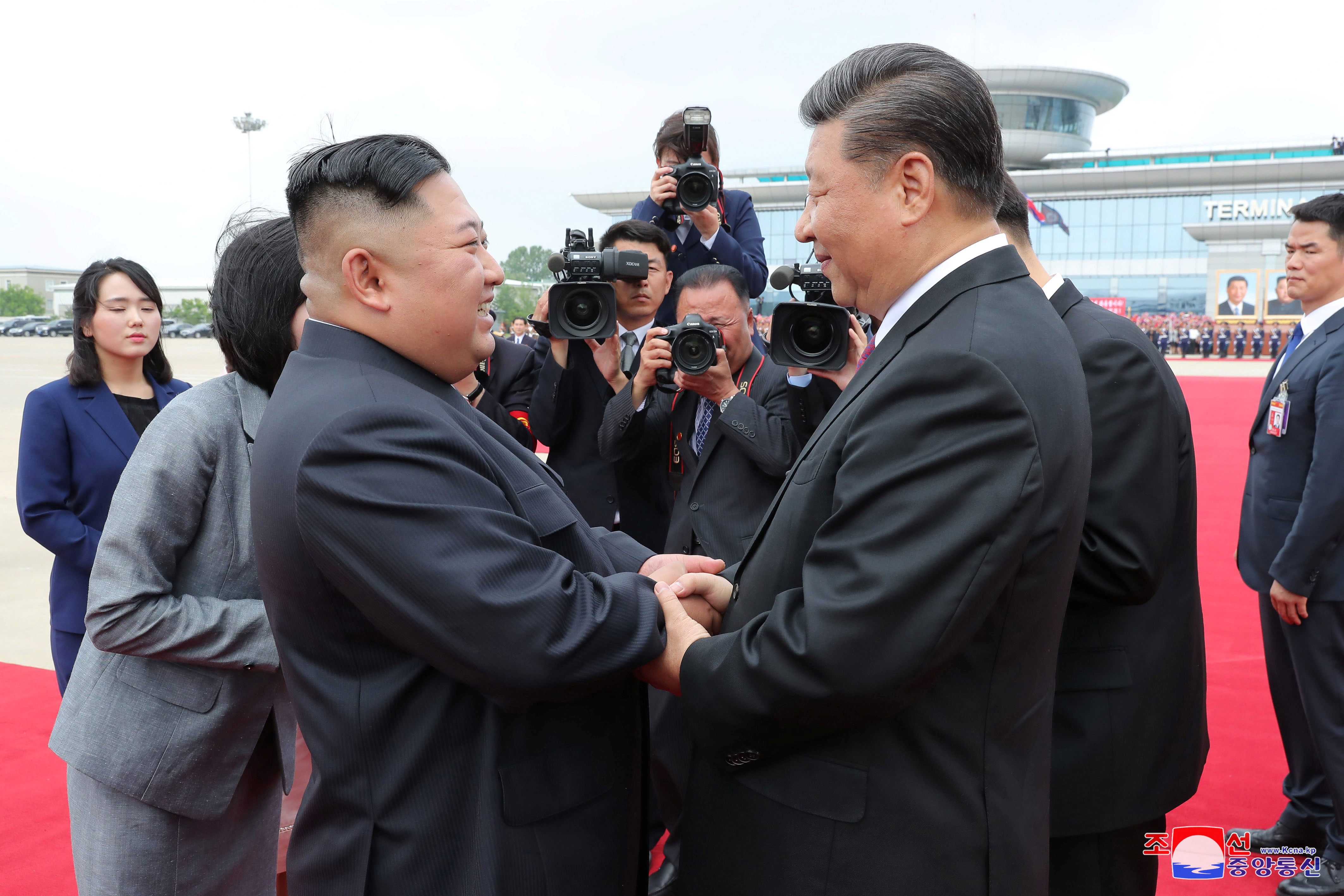FILE PHOTO: North Korean leader Kim Jong Un shakes hands with Chinese President Xi Jinping during Xi's visit in Pyongyang
