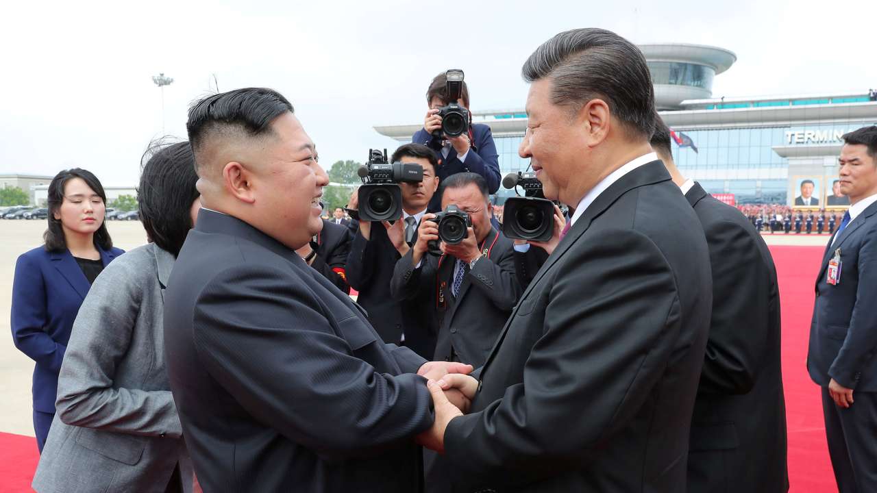 FILE PHOTO: North Korean leader Kim Jong Un shakes hands with Chinese President Xi Jinping during Xi's visit in Pyongyang