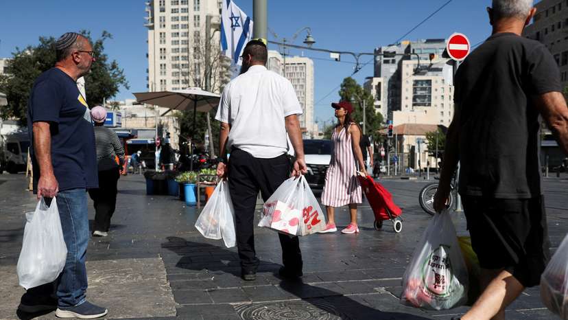 People shop in Jerusalem following an Israeli strike in Iran