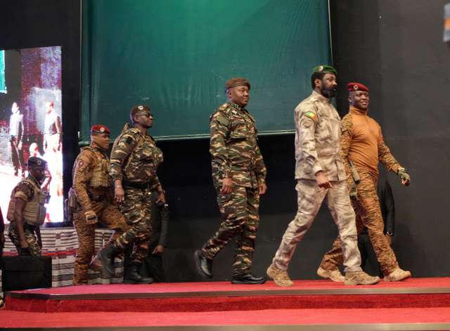 FILE PHOTO: Heads of state of Mali's Assimi Goita, Burkina Faso's Captain Ibrahim Traore and Niger's General Abdourahamane Tiani walk together during the first ordinary summit of heads of state and governments of the Alliance of Sahel States (AES) in Niamey, Niger July 6, 2024. REUTERS/Mahamadou Hamidou/File Photo